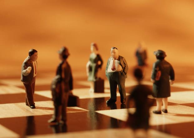 Small business people on chess board