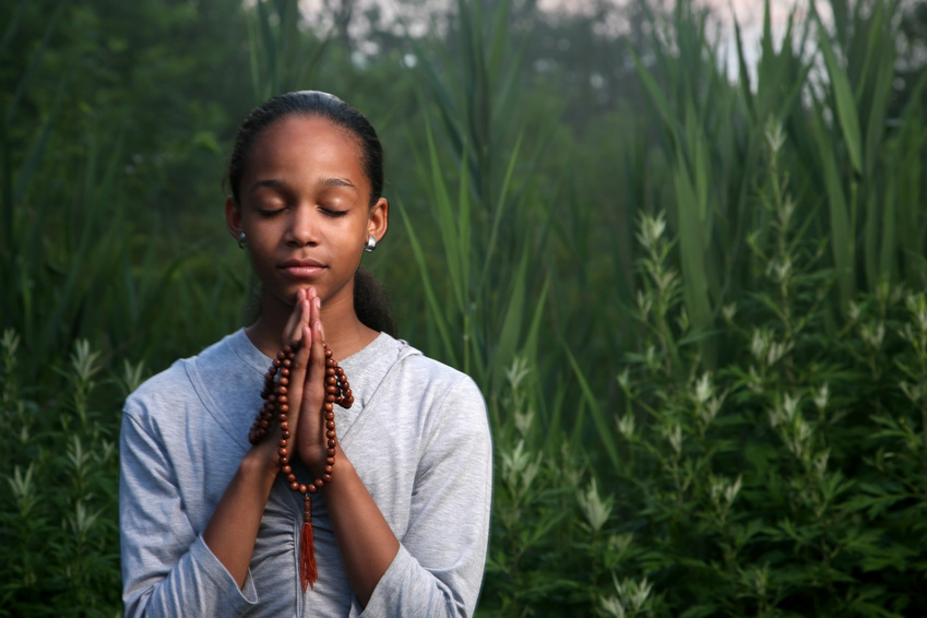 Young girl praying outdoor